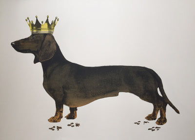 A hand pulled screen print called Royal Sausage. The piece depicts a black and tan Dachshund wearing a golden crown. This naughty doggy has left its footprints all across the page. The footprints and the ear have been printed in a metallic bronze ink. This piece comes unframed and is 50cmx70cm.