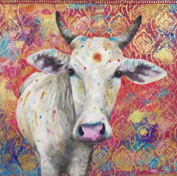 A limited edition giclee print of a beautiful white Indian cow with holy red tika on her forehead. She's placed against a hot pink background interspersed with striking cobalt blue rangoli patterns. There is an ornate gold block print through the background and a pink and gold sari border along the top.