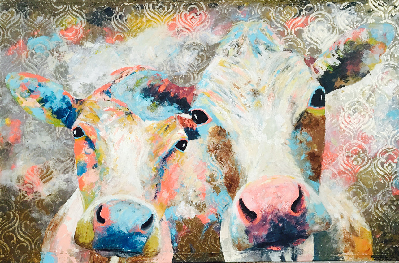 A limited edition giclee print of two cows on archival fine art paper. This image shows 2 cows faces broken into the background using beautiful turquoise and coral tones with gold print overlay.