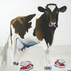 A photographic print of a brown friesian cow with two pairs of 80's trainers.  Mounted on snow white textured mount board. Actual image 6x6inches.